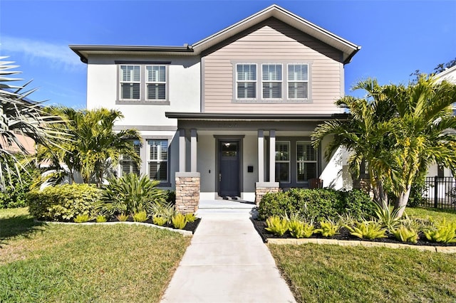 view of front of property with a front yard and covered porch