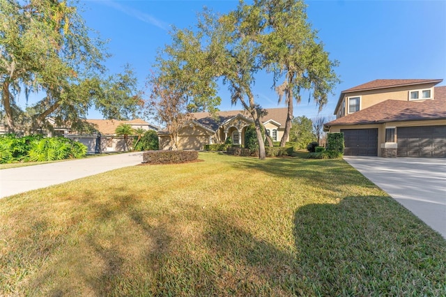 view of front of property with a garage and a front lawn