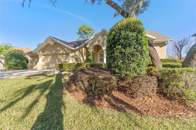 view of front of property featuring a garage and a front lawn