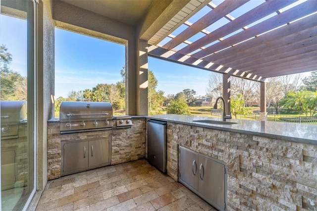 view of patio with sink, a pergola, grilling area, and an outdoor kitchen