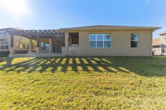 rear view of house featuring a yard and a pergola