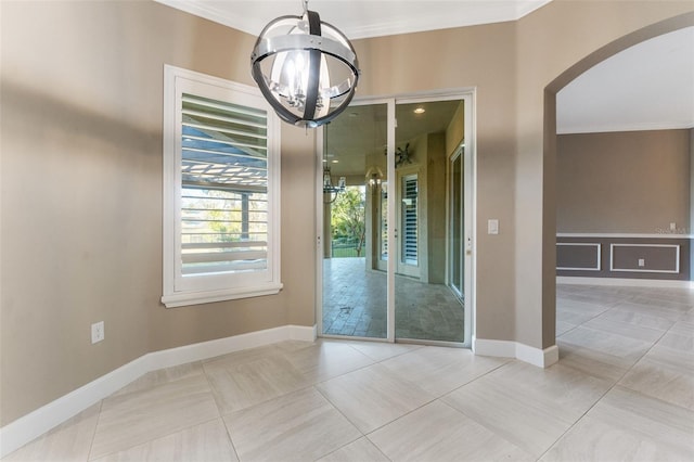 unfurnished dining area featuring crown molding, an inviting chandelier, and light tile patterned floors