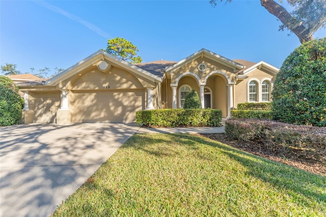 view of front of house featuring a garage and a front lawn