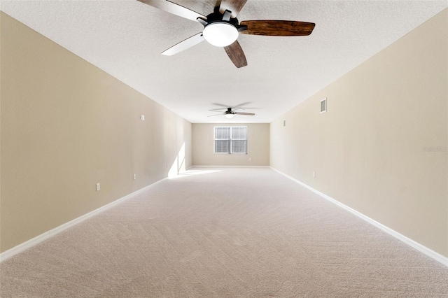 carpeted empty room with ceiling fan and a textured ceiling