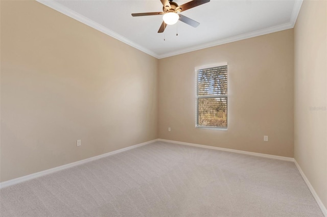 carpeted spare room featuring ornamental molding and ceiling fan