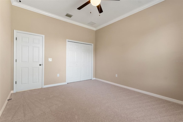 unfurnished bedroom featuring crown molding, a closet, ceiling fan, and carpet