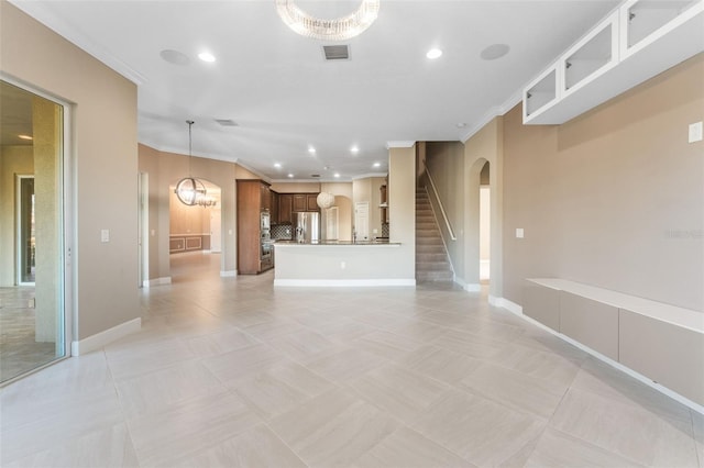 unfurnished living room featuring ornamental molding, a chandelier, and light tile patterned floors