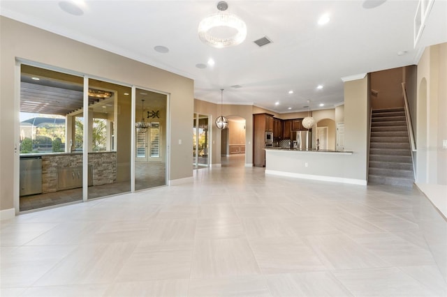 unfurnished living room featuring ornamental molding and light tile patterned flooring