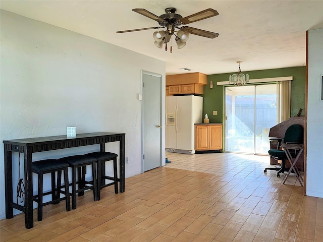 interior space with ceiling fan