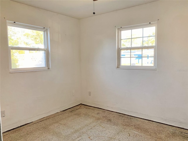 unfurnished room featuring a wealth of natural light