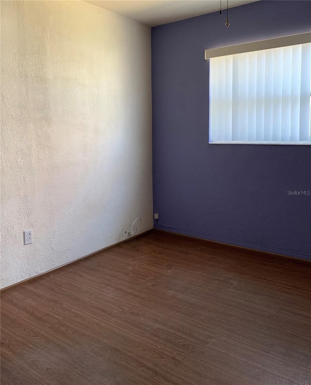 spare room featuring hardwood / wood-style flooring