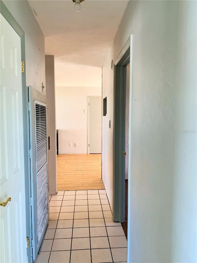 hall with light tile patterned floors