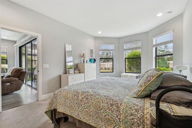 carpeted bedroom featuring recessed lighting, baseboards, and access to outside