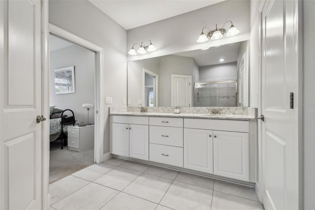 bathroom with a stall shower, a sink, ensuite bath, tile patterned flooring, and double vanity