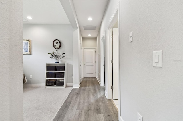 hallway with light hardwood / wood-style floors