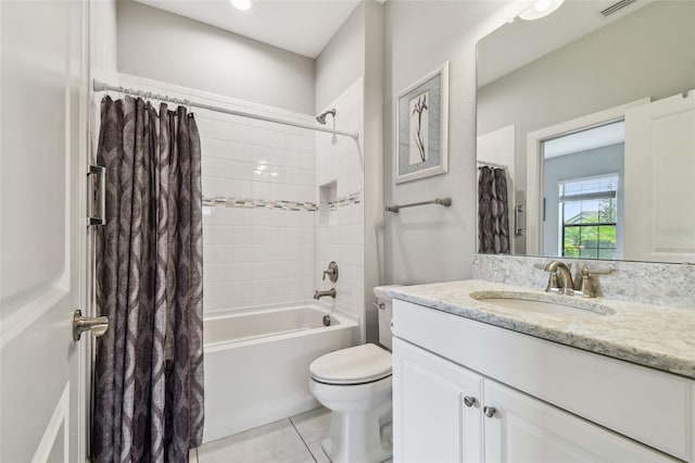 full bathroom with tile patterned floors, toilet, vanity, and shower / bath combination with curtain