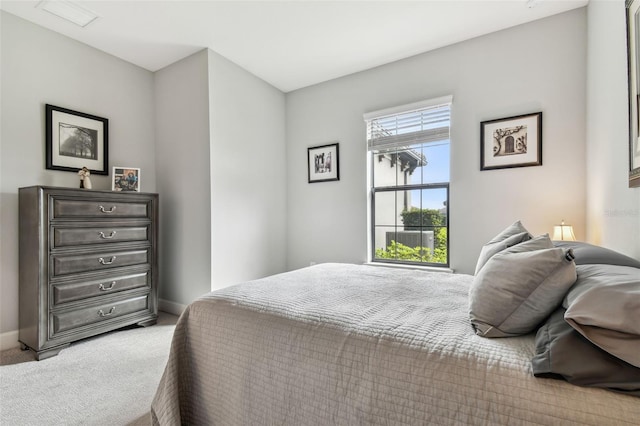 bedroom with baseboards and carpet floors