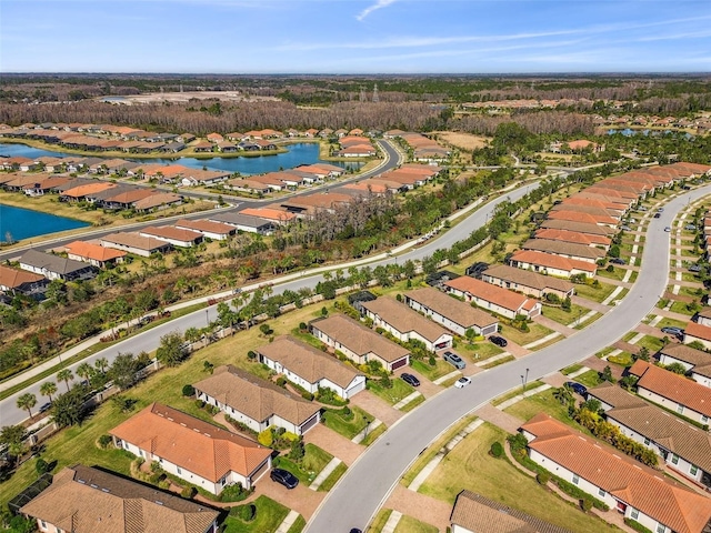 bird's eye view featuring a residential view and a water view