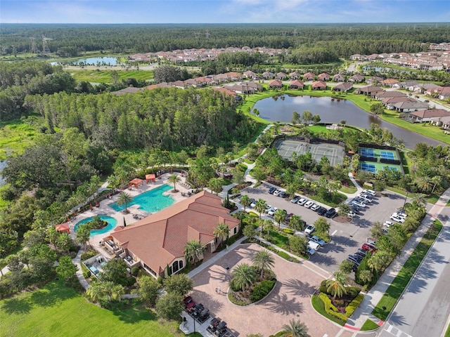 drone / aerial view featuring a view of trees and a water view