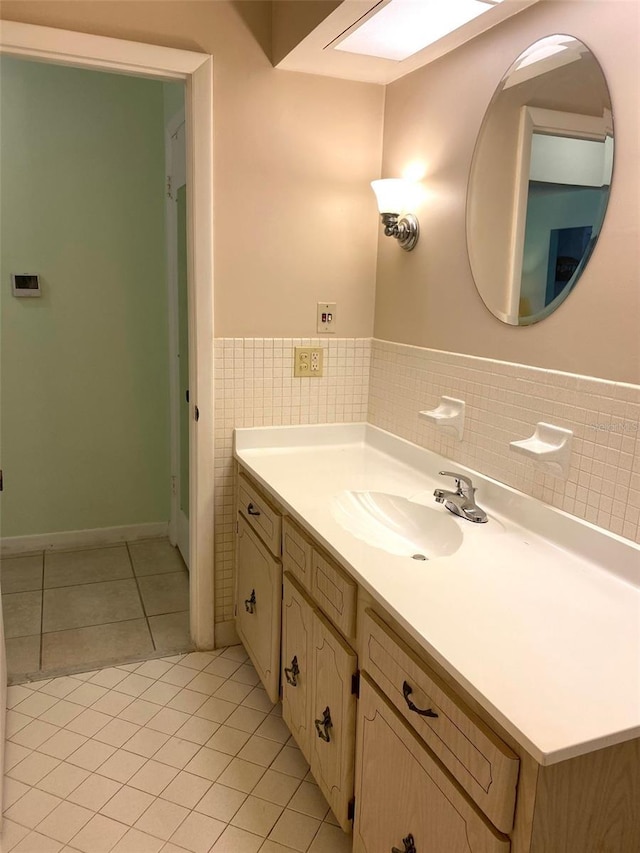 bathroom featuring tile patterned flooring, vanity, and tile walls