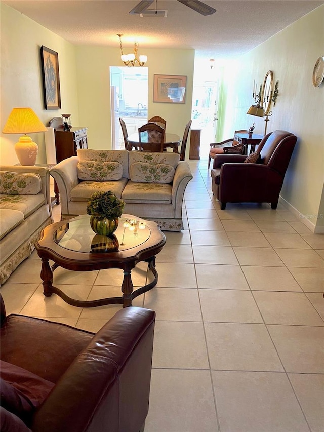 living room with ceiling fan, sink, and light tile patterned floors