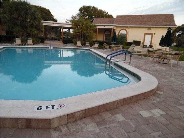 view of swimming pool featuring a patio