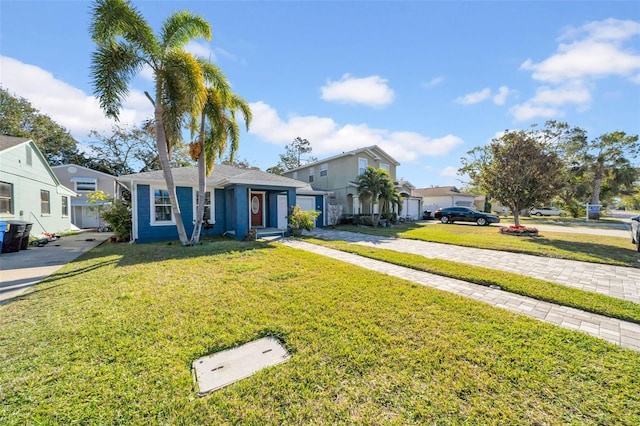 view of front of home with a garage and a front lawn