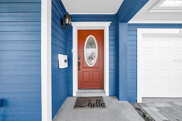 view of exterior entry with a garage