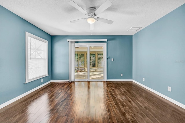 unfurnished room with ceiling fan, dark hardwood / wood-style floors, and a textured ceiling