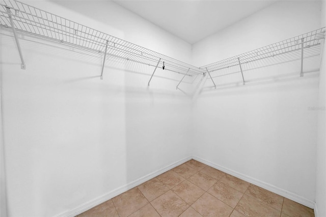 walk in closet with tile patterned floors