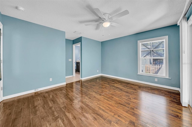 spare room featuring wood-type flooring, a textured ceiling, and ceiling fan