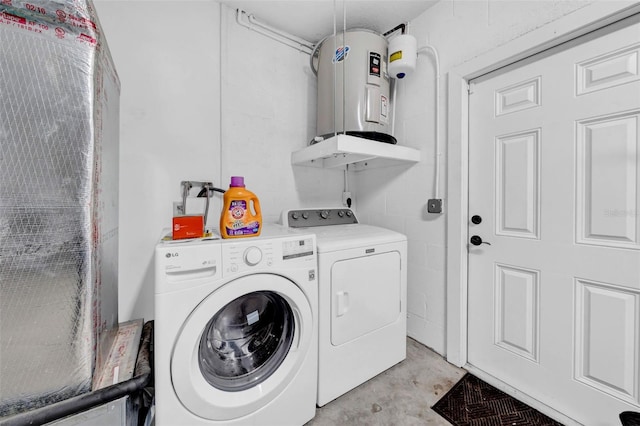 washroom with water heater and washer and dryer