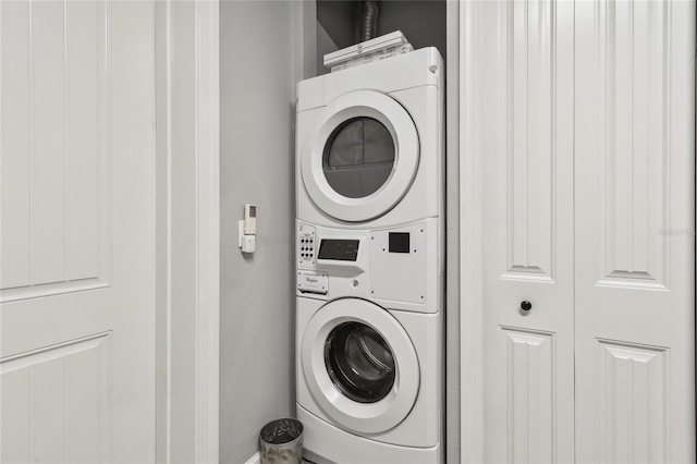 clothes washing area featuring stacked washer / dryer