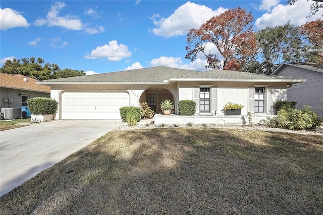 single story home featuring a garage, central AC, and a front yard