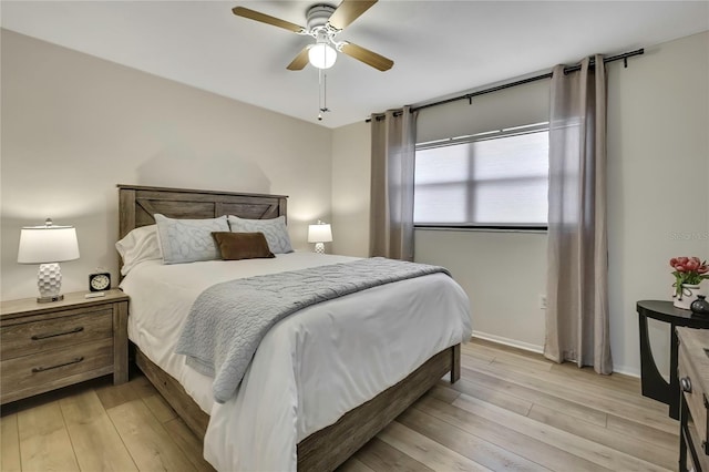 bedroom with ceiling fan and light wood-type flooring