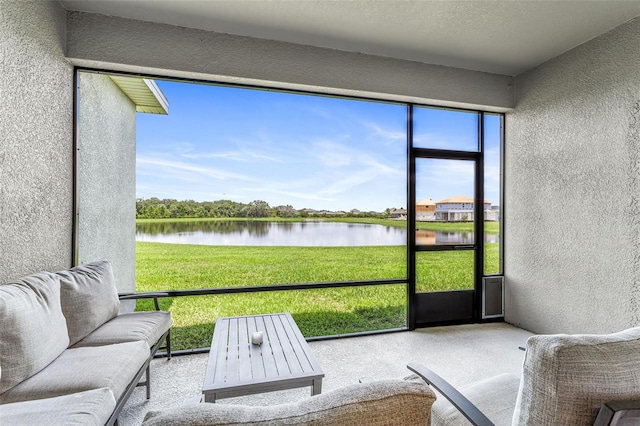 unfurnished sunroom featuring a water view