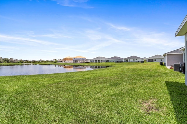 view of yard featuring cooling unit and a water view