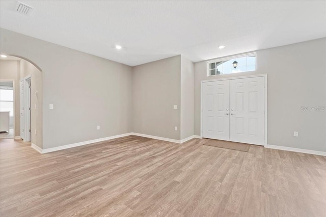 foyer featuring light hardwood / wood-style flooring and a healthy amount of sunlight