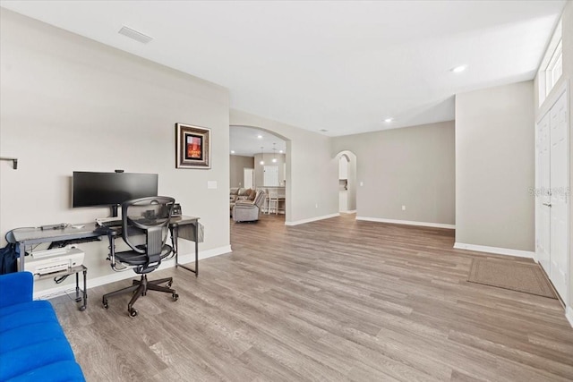 home office with light hardwood / wood-style floors