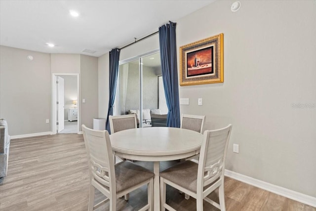 dining space with light hardwood / wood-style floors