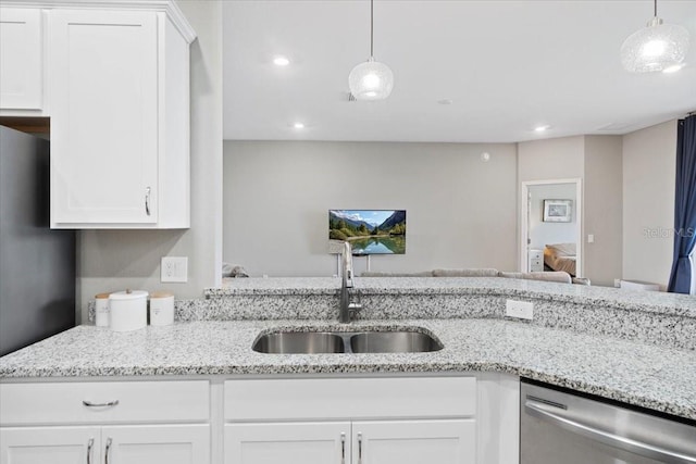 kitchen with pendant lighting, stainless steel appliances, sink, and white cabinets