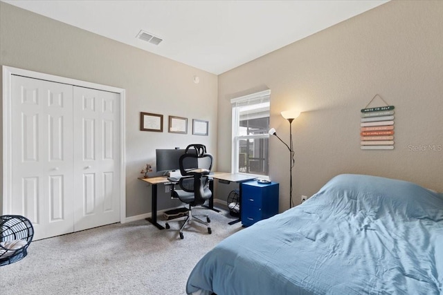 bedroom featuring light carpet and a closet