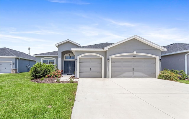 ranch-style home with a garage and a front lawn