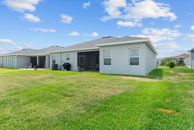 back of property featuring a lawn and central air condition unit