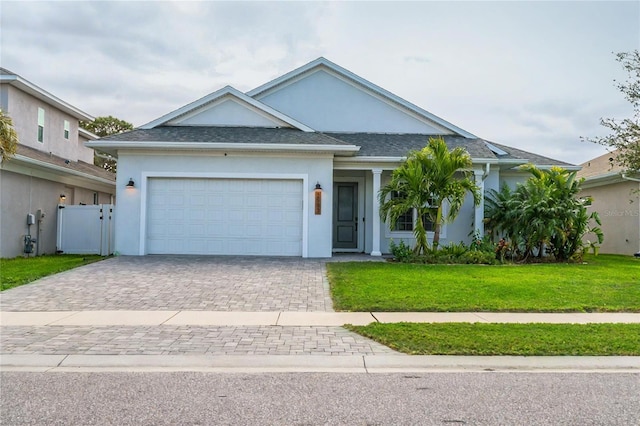 view of front of home with a garage and a front yard