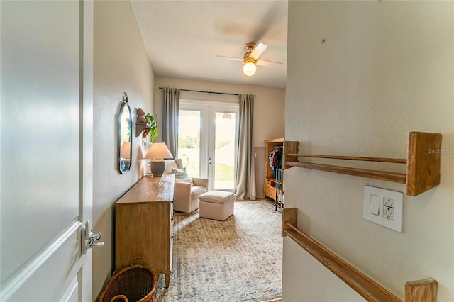 living area with french doors and ceiling fan