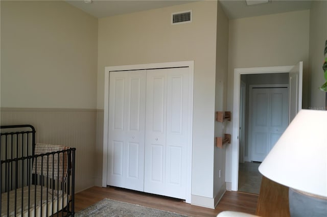 bedroom featuring dark hardwood / wood-style flooring and a closet