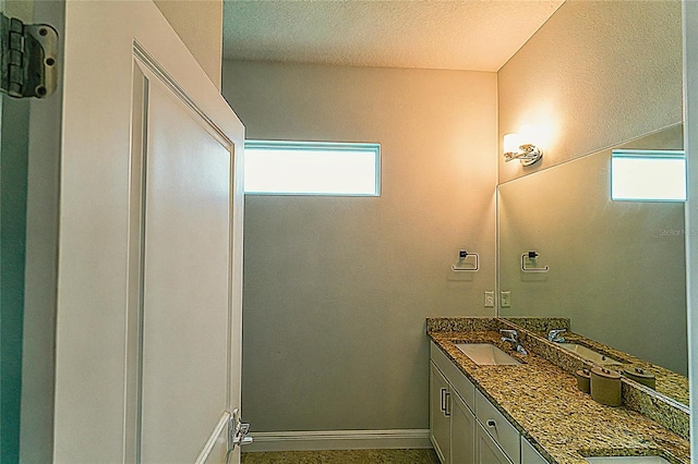 bathroom featuring vanity and a textured ceiling