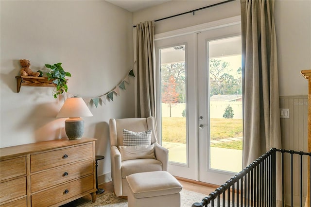 sitting room featuring french doors and light wood-type flooring