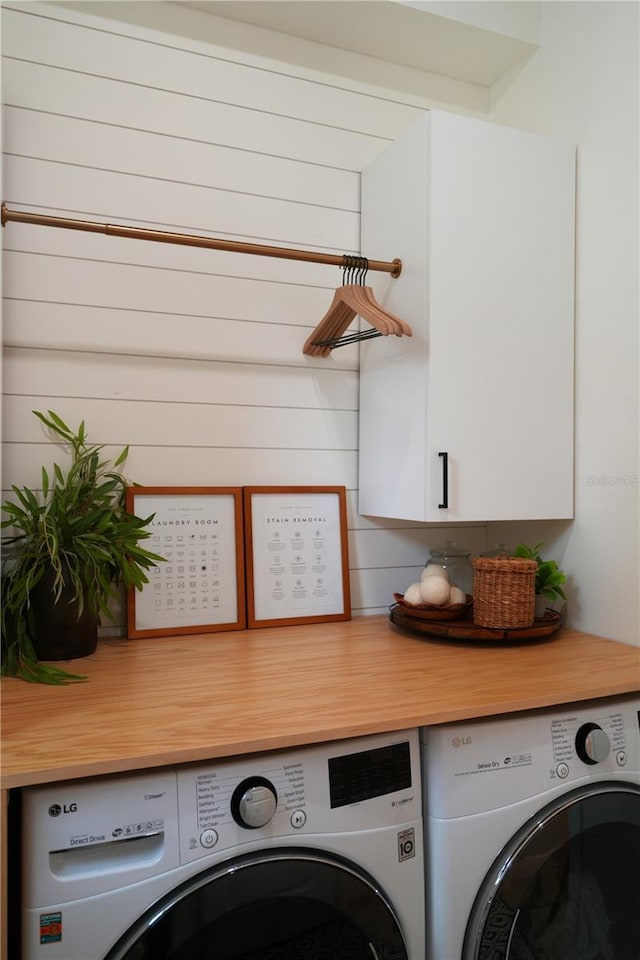 laundry room with cabinets and washer and dryer